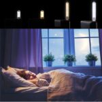 Woman sleeping in a cozy bed at night, with four LED light strips shown above in white, warm yellow, warm white, and blue.
